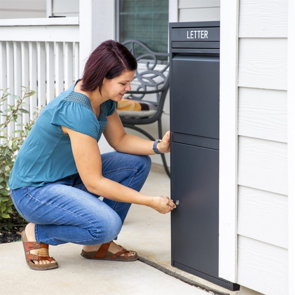 Homeowner unlocking the Feliluke Package Delivery Box to retrieve parcels.