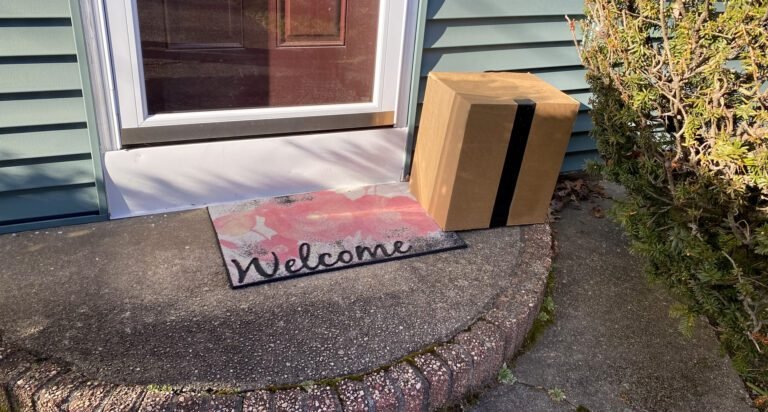 Package left exposed by front door of a residential house