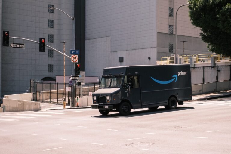 Amazon Prime delivery truck on 4th Street in an urban setting with traffic signals and no entry signs, indicating a one-way street